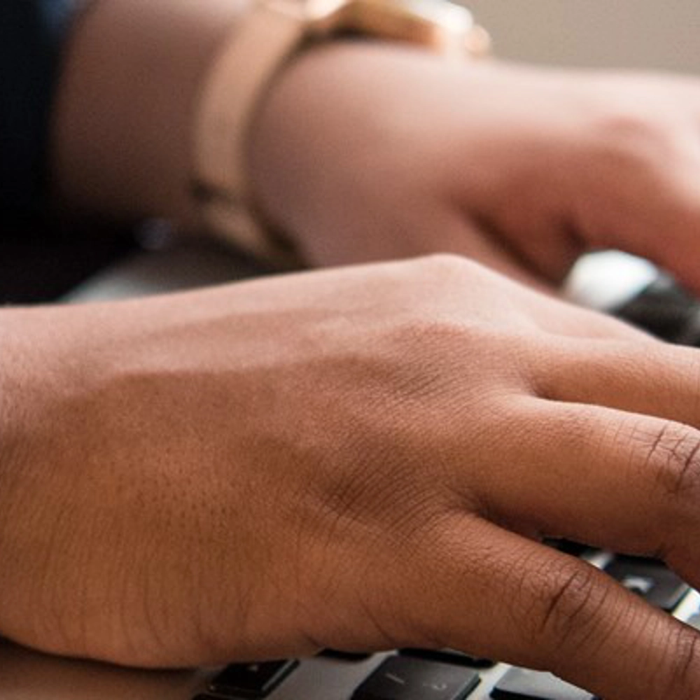 hands typing on keyboard